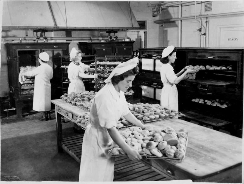 Women baking bread in a commercial kitchen.