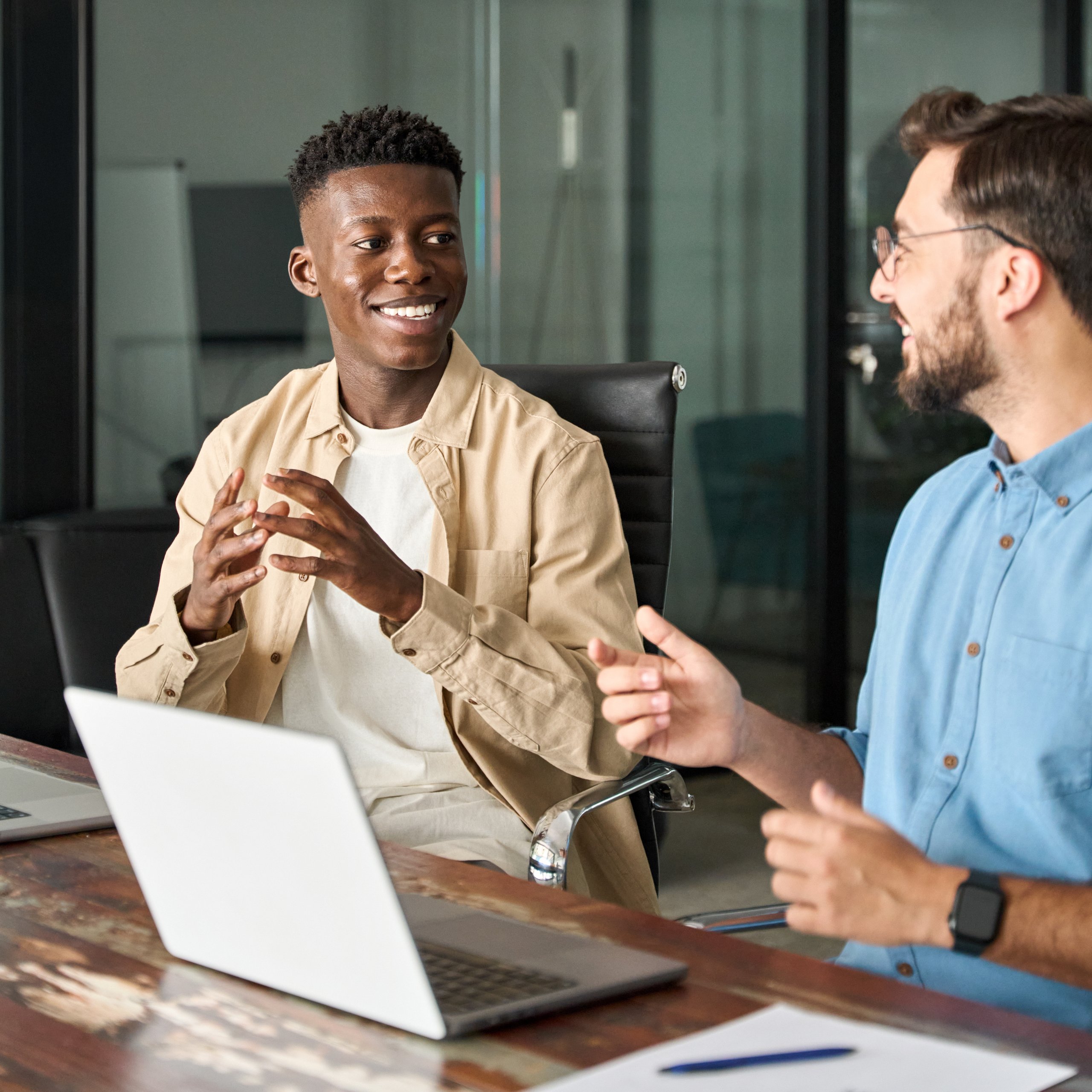 Two men in an office talking.
