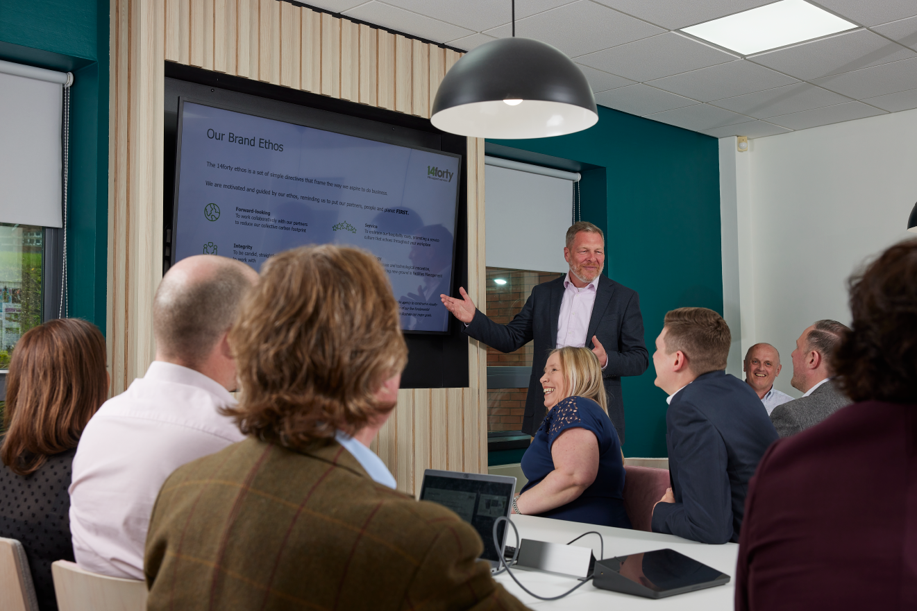 Man giving a presentation to a group of people at a conference.