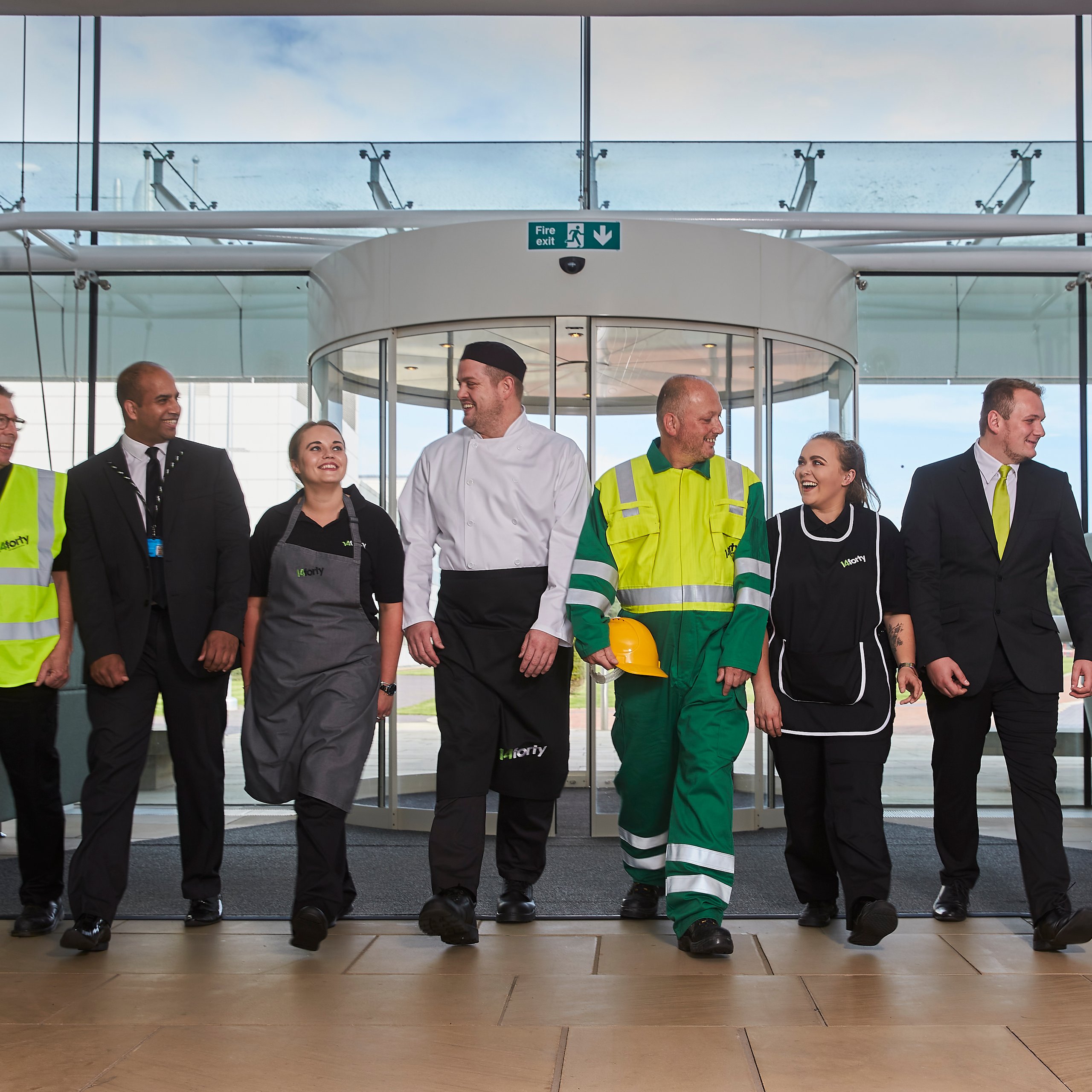 Diverse group of people, various professions, smiling.