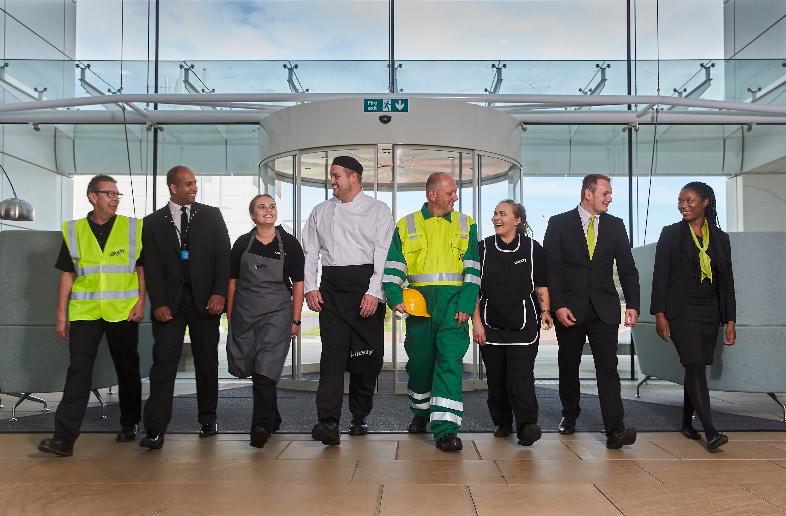 Diverse group of people, various professions, smiling.