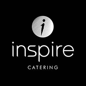 The logo for Inspire Catering features a stylized lowercase 'i' inside a silver circle above the word "inspire" in white sans-serif font, with "CATERING" below it in smaller white uppercase letters on a black background.